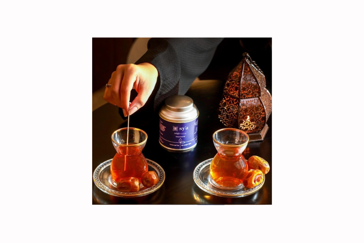 a reflective tea moment with sy’a twilight mint tea, served in traditional glasses with dates and a glowing lantern, evoking artistic, cultural, and ritualistic heritage.