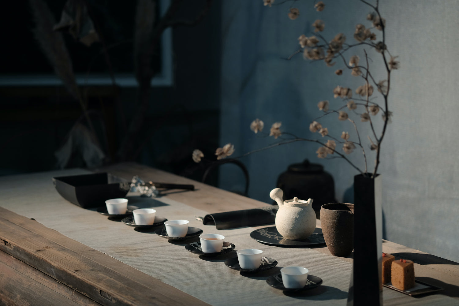 tea table setting with 6 cups and kettle