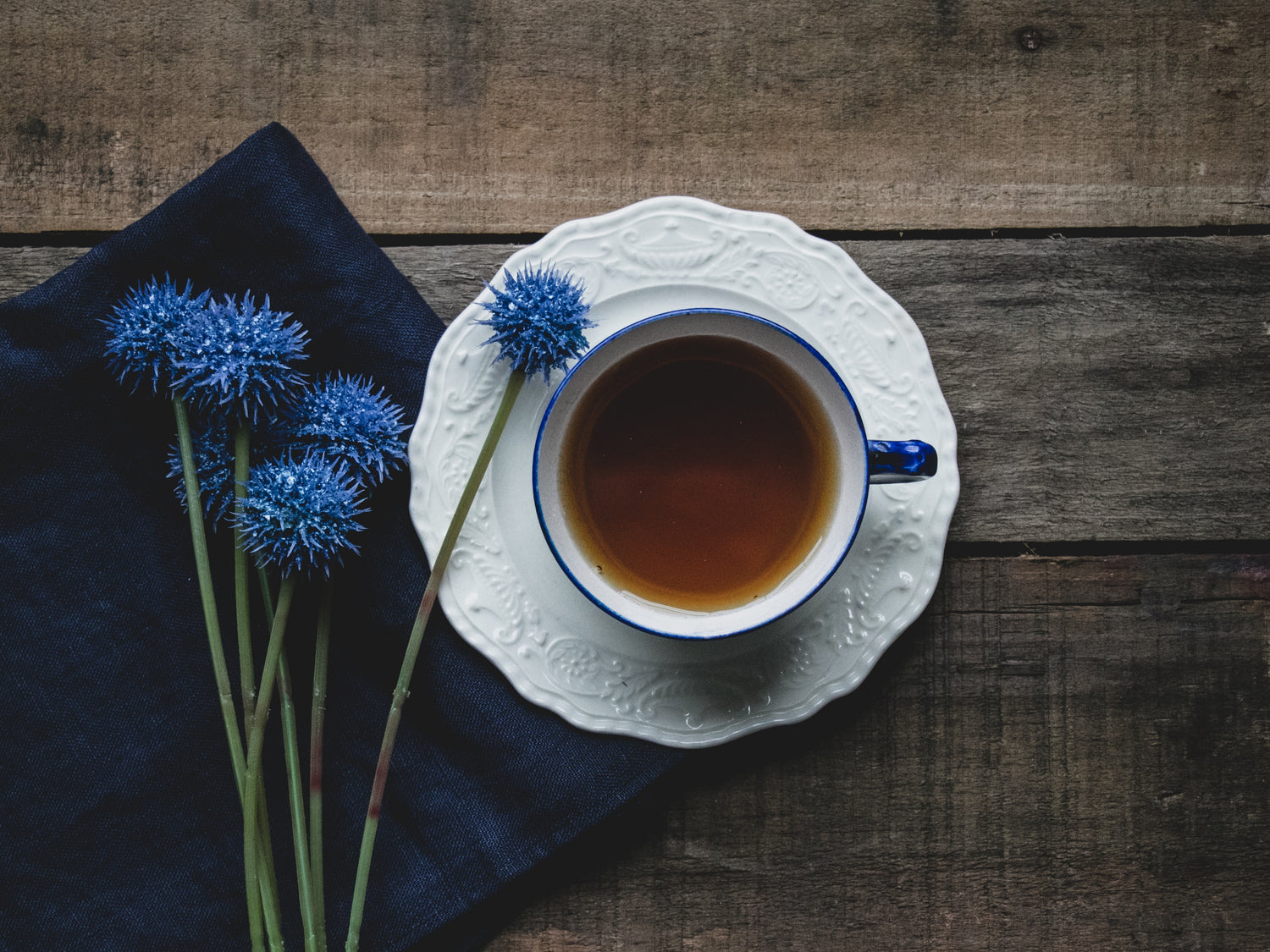 tea cup with blue flowers beside